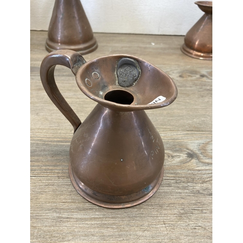 382 - Five 19th century copper graduating measuring jugs, three bearing HR lead seals