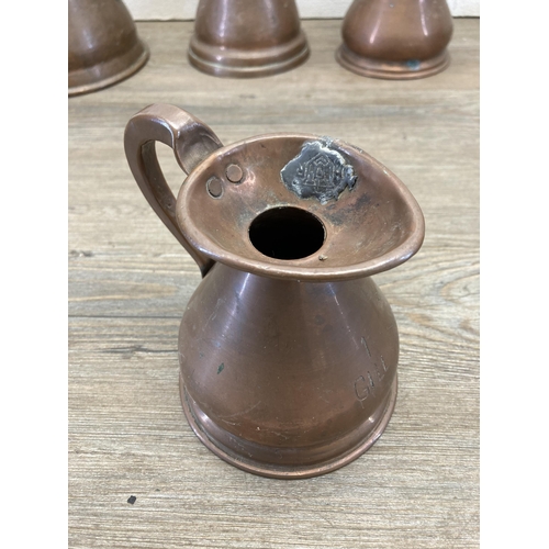 382 - Five 19th century copper graduating measuring jugs, three bearing HR lead seals