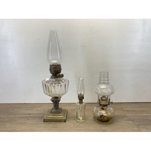 387 - Three 19th century and later oil lamps - largest approx. 55cm high