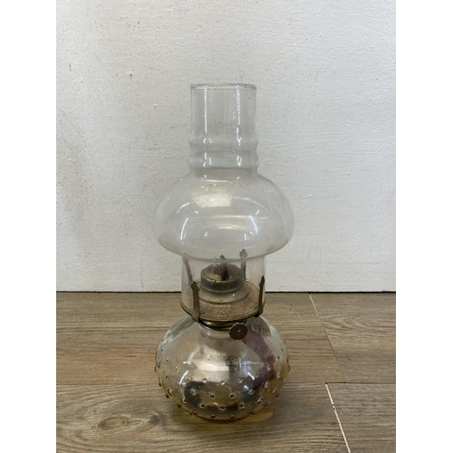 387 - Three 19th century and later oil lamps - largest approx. 55cm high