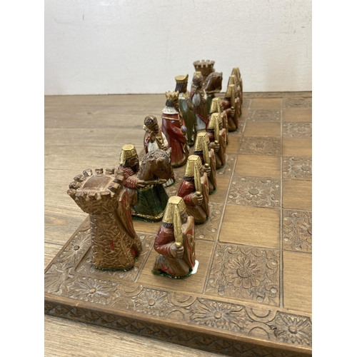 397 - A Jaques London chess set with carved hardwood board and hand painted resin pieces - board approx. 4... 