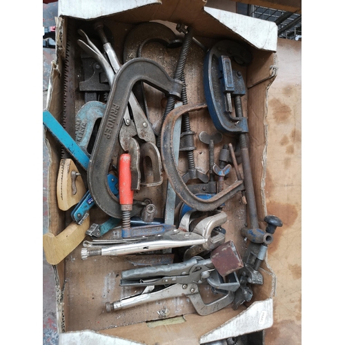 793 - Two boxes containing tools to include nine various size cast iron G-Clamps, heavy duty drill bits et... 