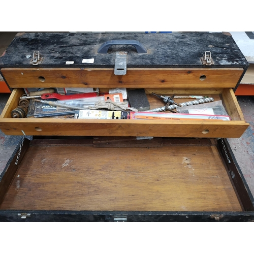 802 - A mid 20th century ebonised pine carpenter's tool chest containing tools with fall front and two int... 