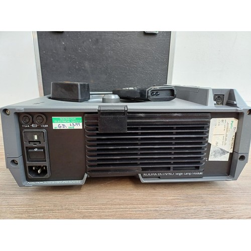 569 - A cased Kodak Ektapro 3000 slide projector fitted with with Docter Vario-Doctarlux lens with remote ... 