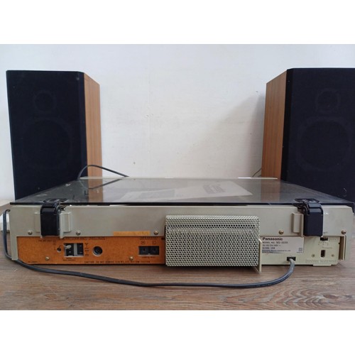 597 - A Panasonic SG-3220 stereo music centre comprising two speed turntable, Dolby cassette deck, three b... 