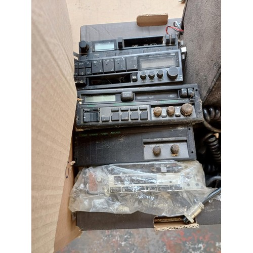 598 - Two boxes containing a large collection of car stereos, CB radios and accessories for spares or repa... 