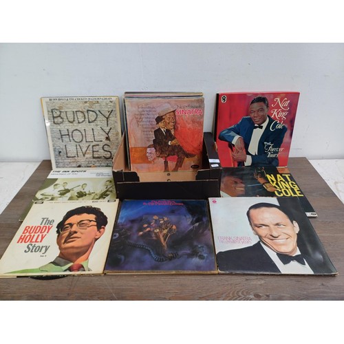 613 - A box containing LP vinyl records to include Nat King Cole, Stevie Wonder, Buddy Holly, The Moody Bl... 