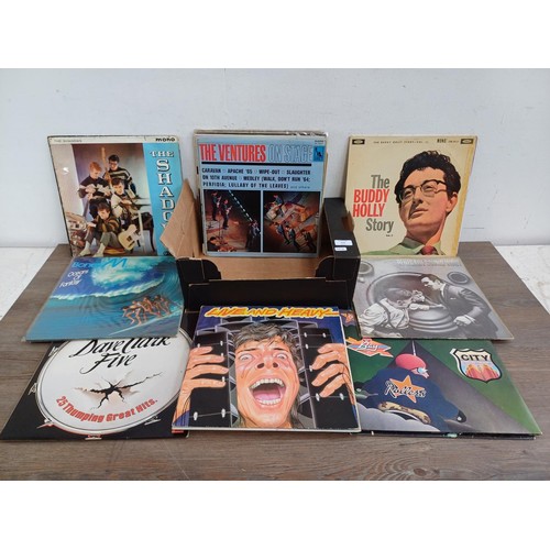 614 - A box containing a collection of LP vinyl records to include The Beatles, Elvis Presley, The Strangl... 