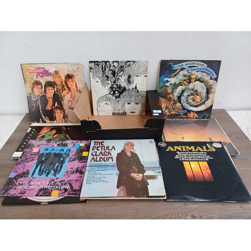 614 - A box containing a collection of LP vinyl records to include The Beatles, Elvis Presley, The Strangl... 