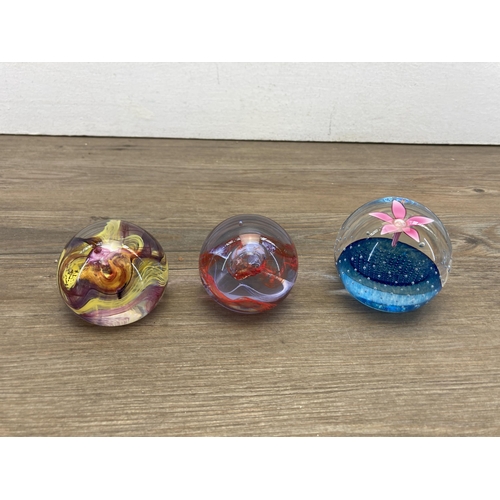 338 - Seven Caithness glass paperweights to include two Floral Dance, moon crystal, blue splash etc.