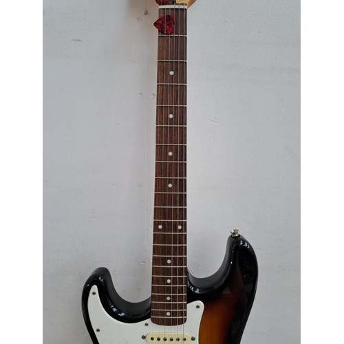 635 - Two items, one cased left handed 2005 Squier Stratocaster electric guitar with two electronic tuners... 