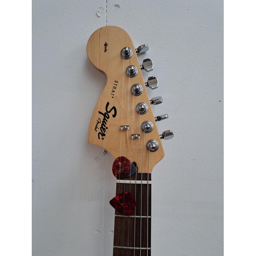 635 - Two items, one cased left handed 2005 Squier Stratocaster electric guitar with two electronic tuners... 