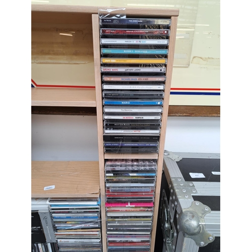 636 - A CD storage unit containing CDs to include Adele, Tracy Chapman, Coldplay, Fleetwood Mac, Eric Clap... 