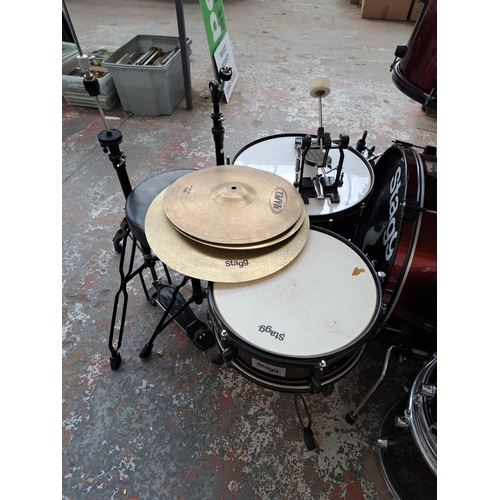 640 - A Stagg five piece drum kit comprising bass drum with pedal, two rack toms, floor tom, snare with st... 