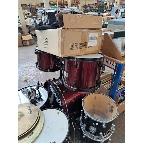 640 - A Stagg five piece drum kit comprising bass drum with pedal, two rack toms, floor tom, snare with st... 