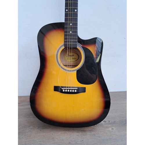 643 - A Squier SA-105CE steel strung Dreadnought electro acoustic guitar with a set of Martin .012 phospho... 