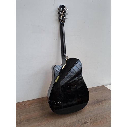 643 - A Squier SA-105CE steel strung Dreadnought electro acoustic guitar with a set of Martin .012 phospho... 