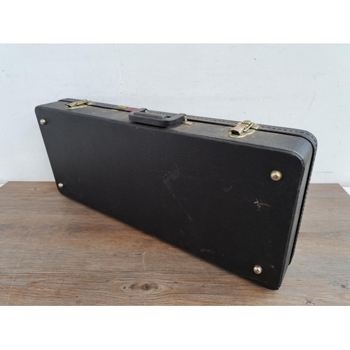 649 - A Gold Tone hard case for flat back mandolin containing guitar strings, plectrums, bridge pins etc.