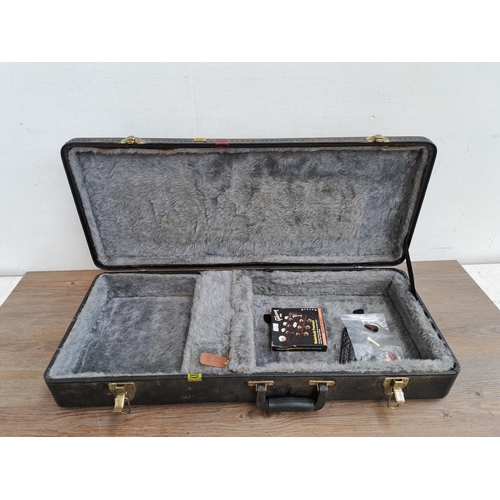 649 - A Gold Tone hard case for flat back mandolin containing guitar strings, plectrums, bridge pins etc.