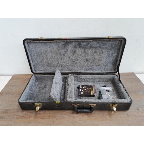 649 - A Gold Tone hard case for flat back mandolin containing guitar strings, plectrums, bridge pins etc.