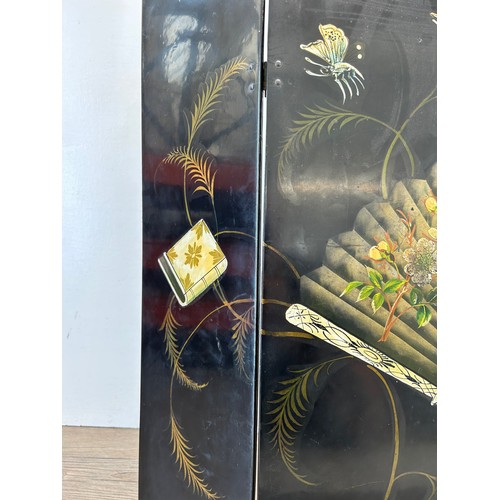 488 - An early 20th century Oriental black lacquered and hand painted three section folding fire screen - ... 