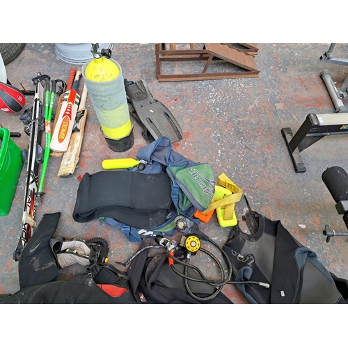 759 - A collection of scuba diving equipment to include flippers, wetsuits, spiro supra oxygen meter etc.