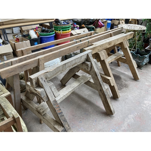 879 - A set of five wooden trestles - longest approx. 310cm long and tallest approx. 83cm high