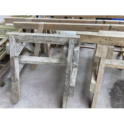 879 - A set of five wooden trestles - longest approx. 310cm long and tallest approx. 83cm high