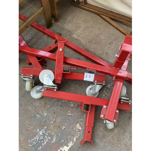 884 - A pair of cast metal adjustable chassis dollies