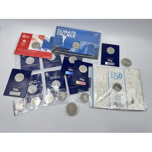 2293 - A collection of British commemorative coins to include Pobjoy Mint Climate Change £1 coin, The Royal... 