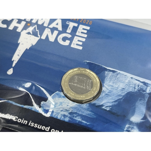 2293 - A collection of British commemorative coins to include Pobjoy Mint Climate Change £1 coin, The Royal... 