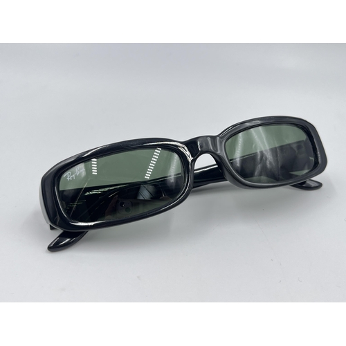 2295 - A cased pair of Ray-Ban RB2127 sunglasses