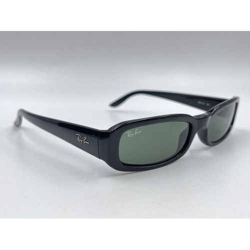 2295 - A cased pair of Ray-Ban RB2127 sunglasses