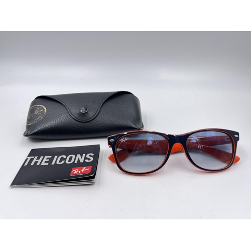 2296 - A cased pair of Ray-Ban New Wayfarer Luxottica sunglasses