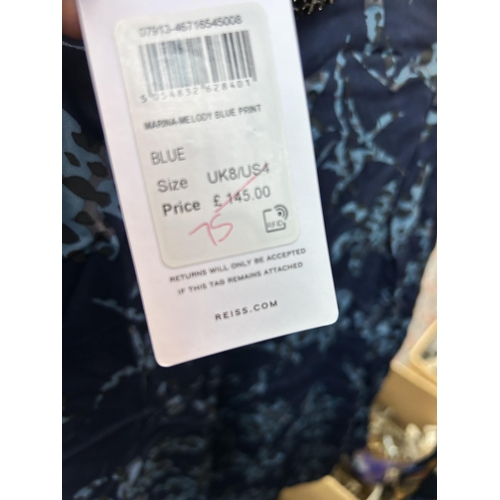 464 - A collection of tagged women's clothing to include Ted Baker dark blue Stardust mini skirt, Saint Tr... 