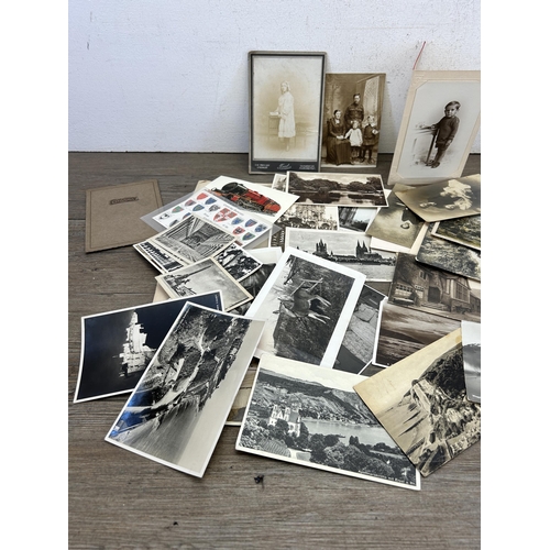 480 - A collection of 19th century and later black and white postcards and photographs