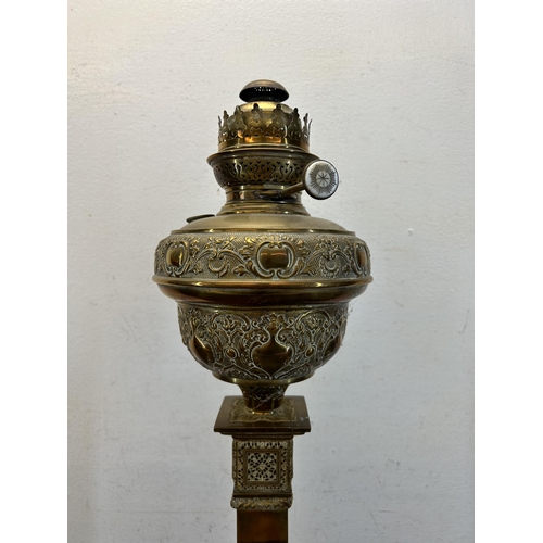 501 - A 19th century ornate brass oil lamp on stepped base - approx. 62cm high