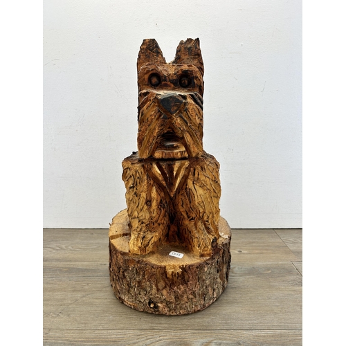 522 - A chainsaw carved tree trunk Scottie dog statue - approx. 48cm high