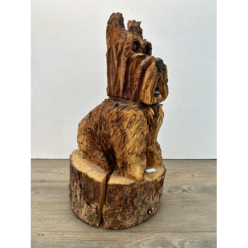 522 - A chainsaw carved tree trunk Scottie dog statue - approx. 48cm high