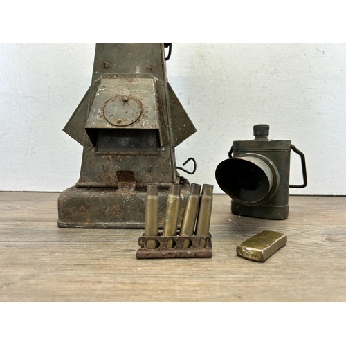 544 - Four WWII items to include Seigneur brass pocket petrol lighter, marking lantern etc.