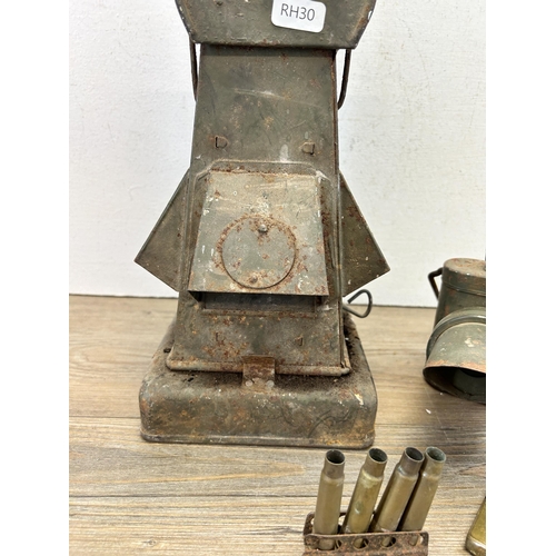 544 - Four WWII items to include Seigneur brass pocket petrol lighter, marking lantern etc.