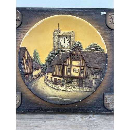 559 - A mid 20th century hand painted chalkware illuminating wall clock depicting village scene - approx. ... 