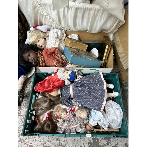 931 - A large collection of porcelain dolls together with cot and games