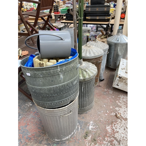 872 - Five galvanised fire bins together with bamboo shoots, chicken wire, galvanised effect dolly tub and... 