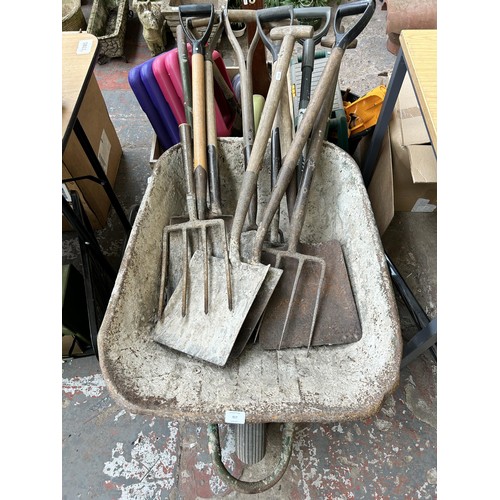 917 - A wheelbarrow containing ten pitchforks and spades