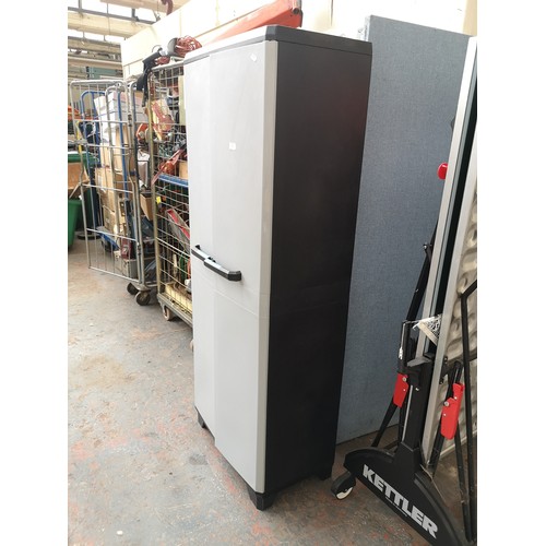 772 - A plastic two door storage unit with three internal shelves - approx. 173cm high x 68cm wide x 38cm ... 