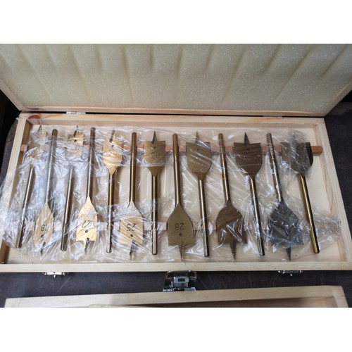 864 - Four cased drill bit sets