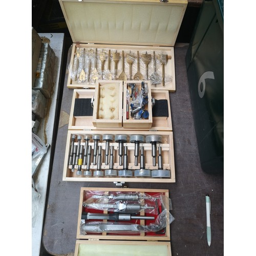 864 - Four cased drill bit sets