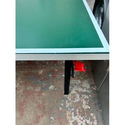 752 - A Kettler folding table tennis table with net, paddles and balls