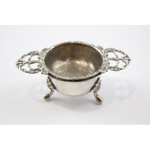 2257 - A Mappin & Webb hallmarked Birmingham sterling silver tea strainer and stand, dated 1971 - approx. g... 